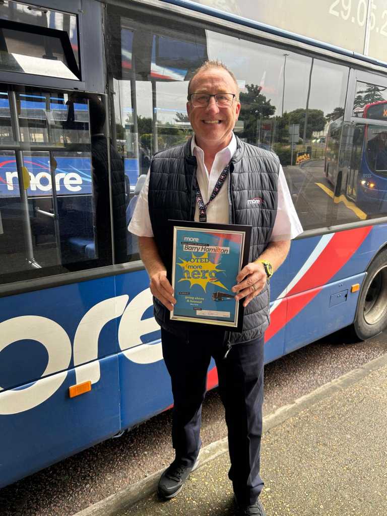 Barry holding up his certificate