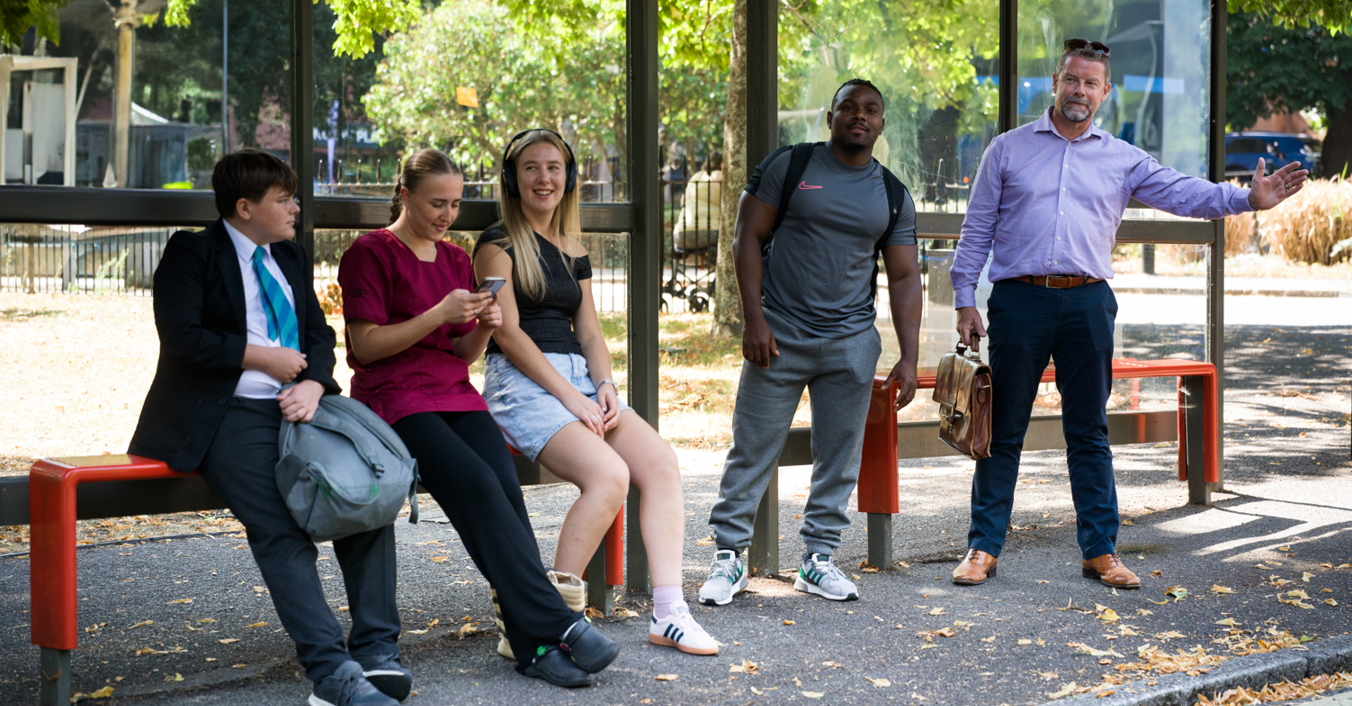Group of people at bus stop