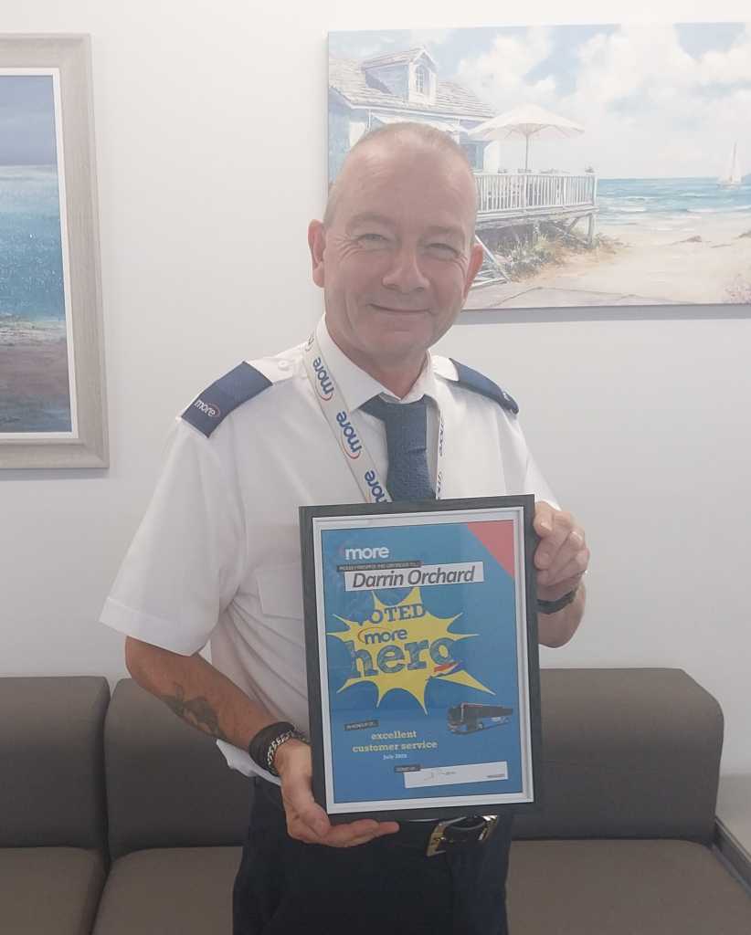 Darrin holding up his certificate