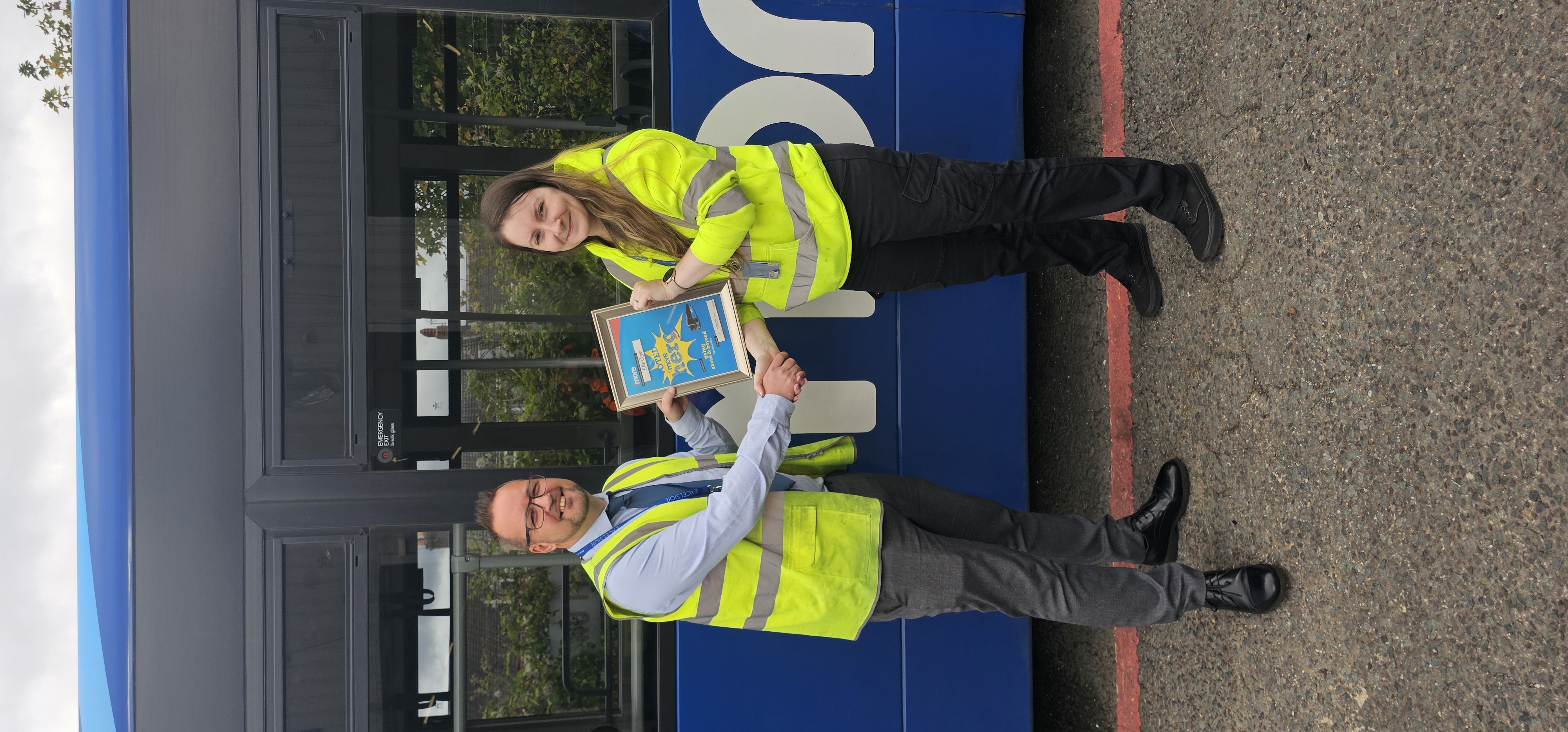 Manager presenting Ellie with her certificate and voucher