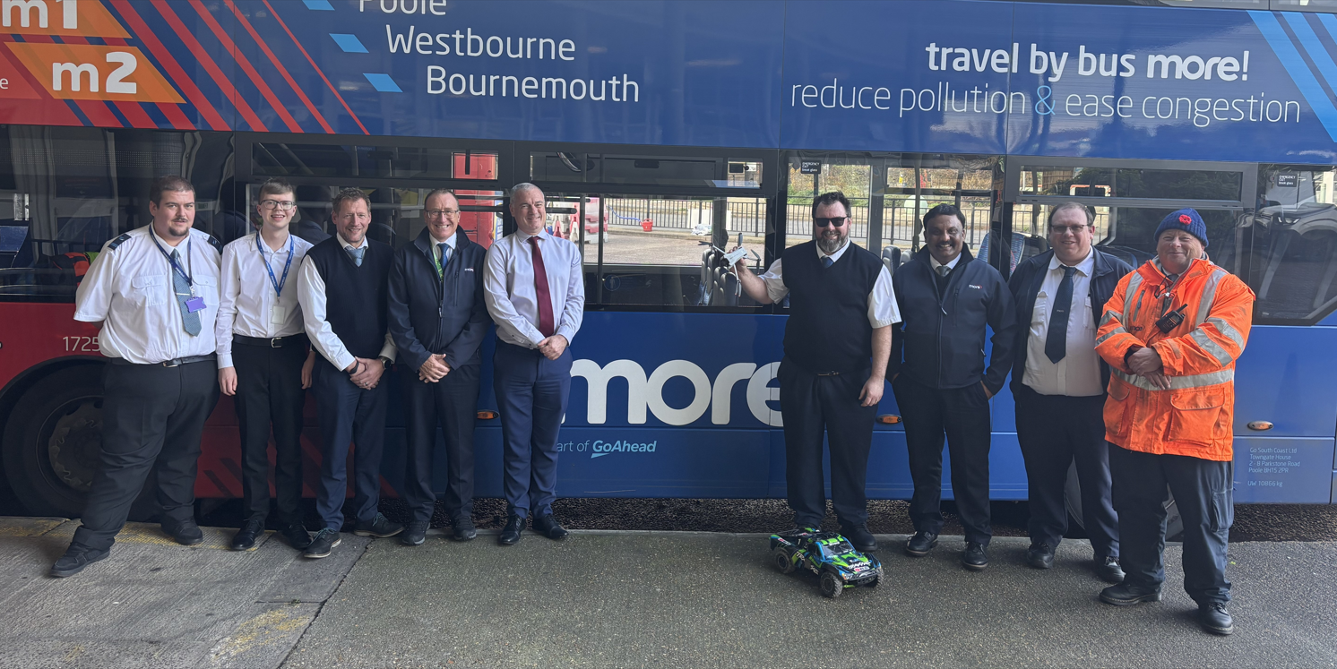 Group of men stood by a Morebus