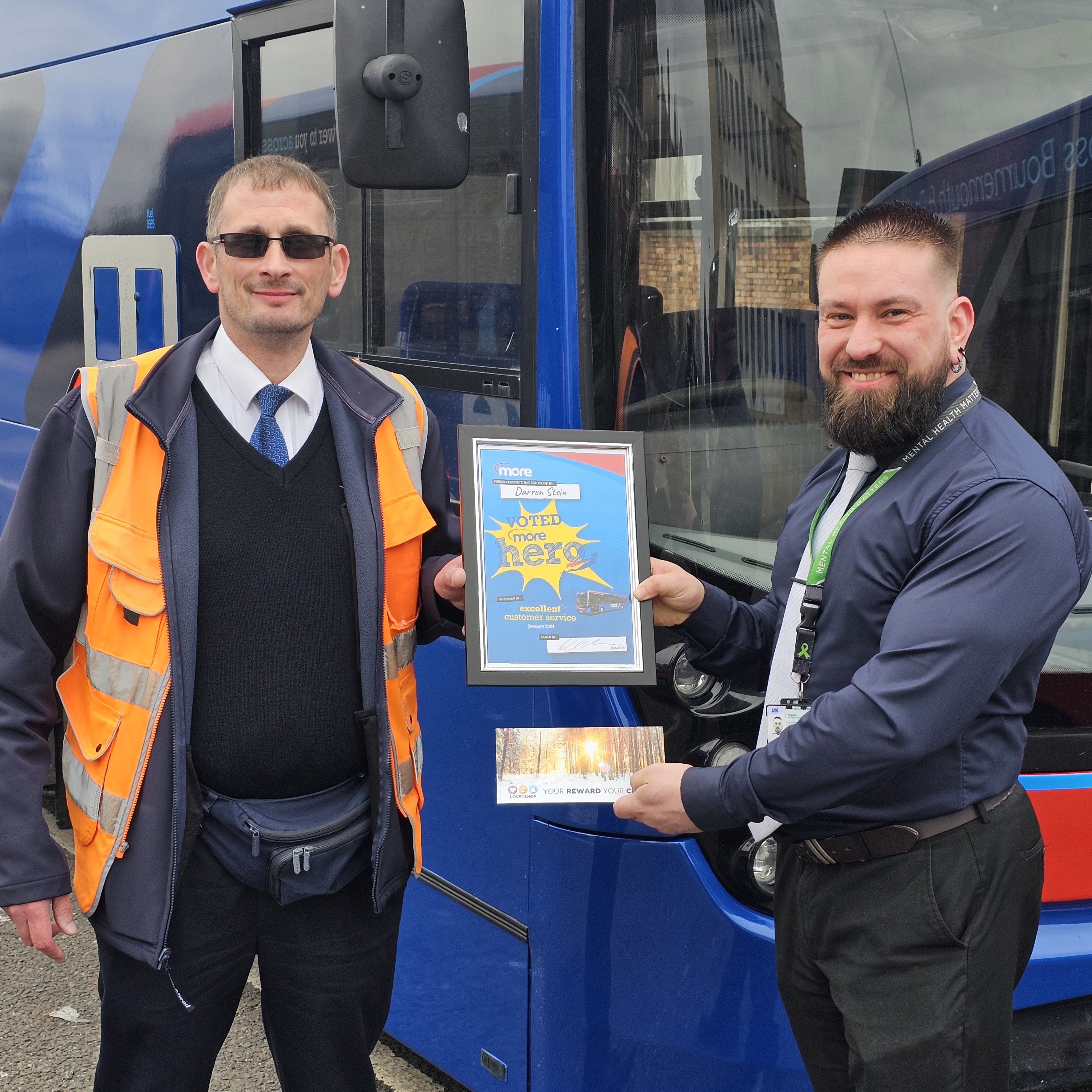 driving being presented an award by a manager