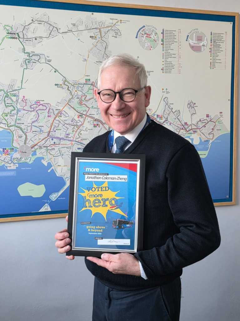 Jonathan holding up his certificate