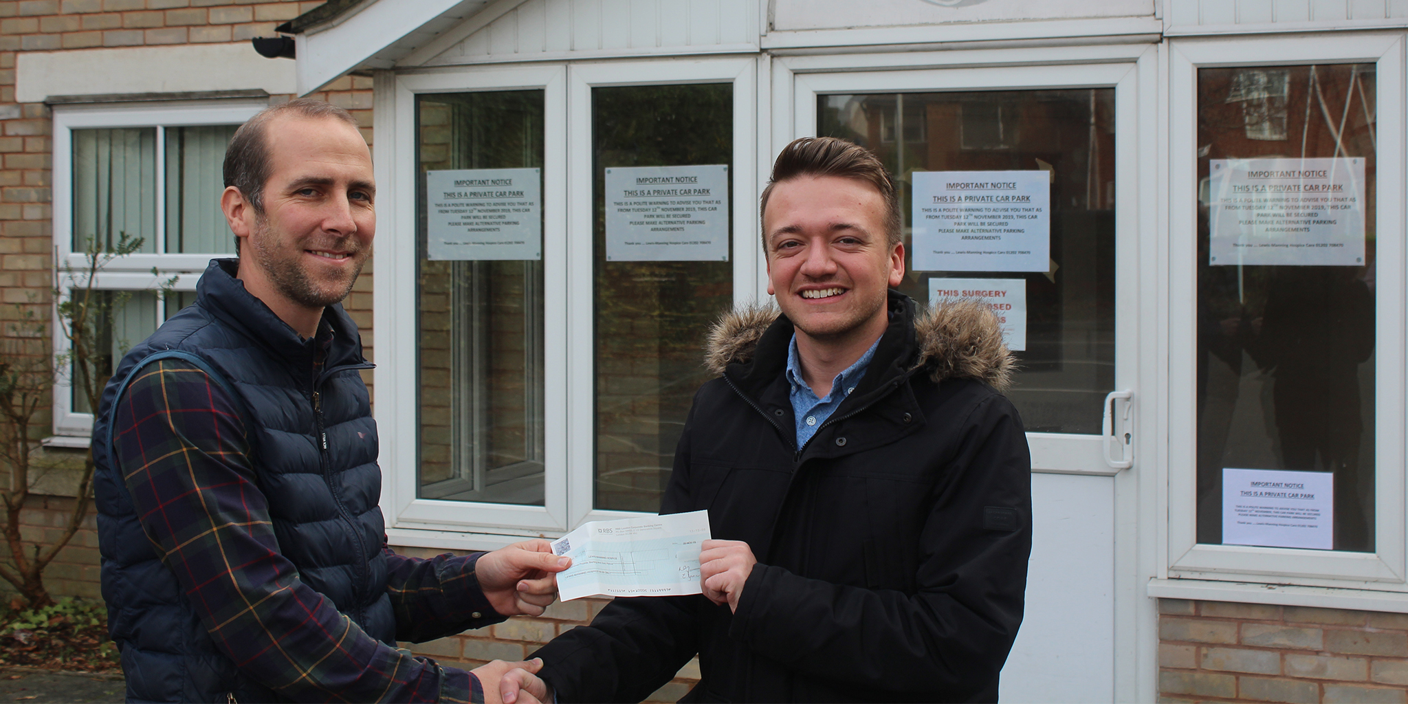 Photo of Lewis-Manning Hospice's Tom Goodinge being presented with a cheque by morebus's Joe Quinlan