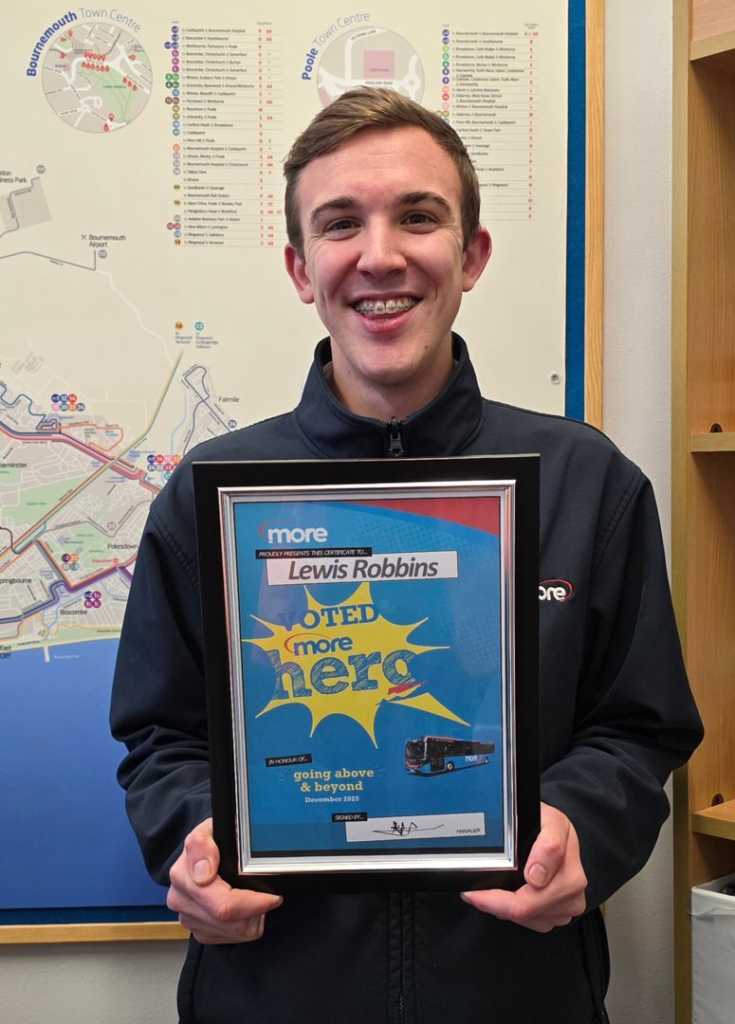 Lewis holding up his certificate