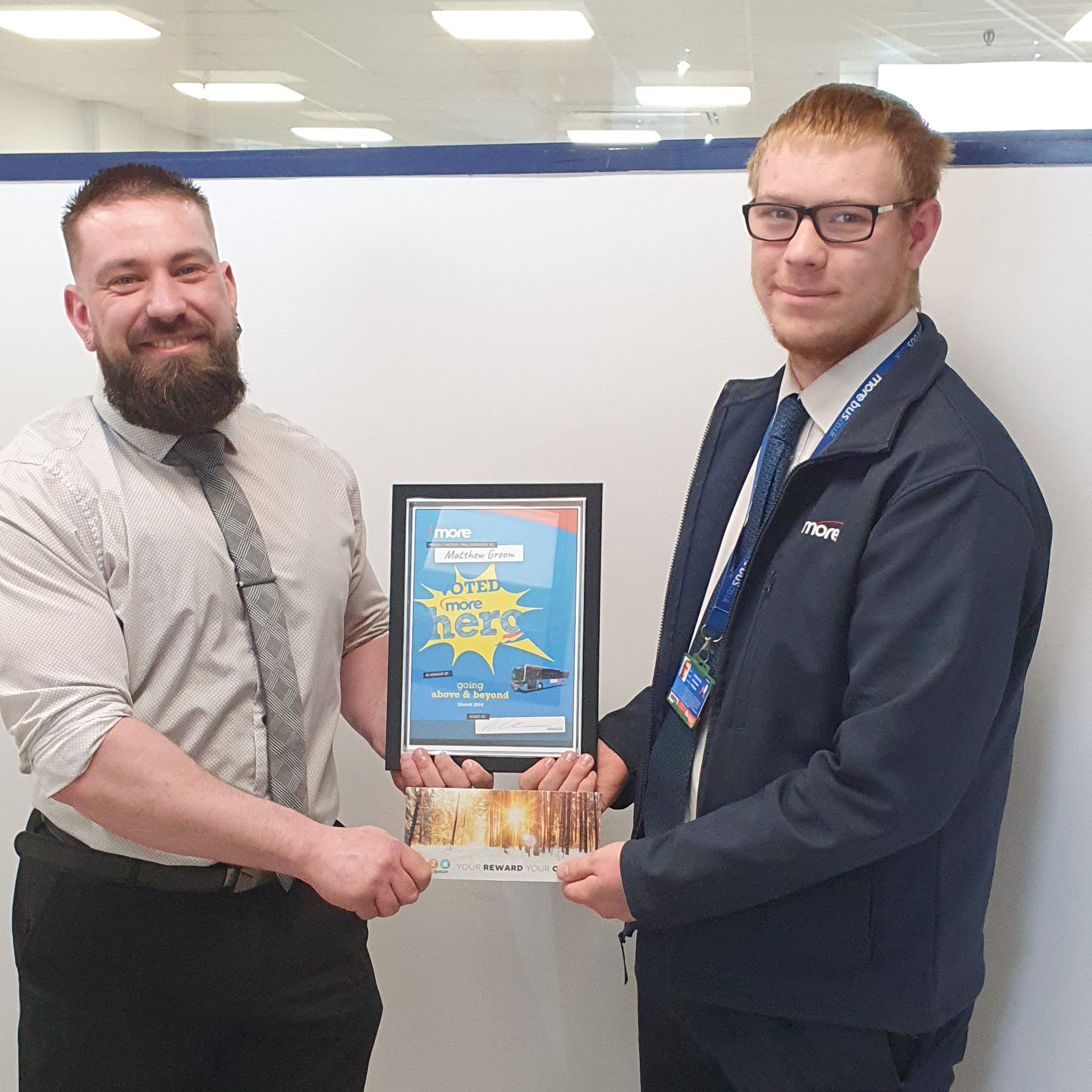 manager presenting Matthew with his more hero certificate and voucher