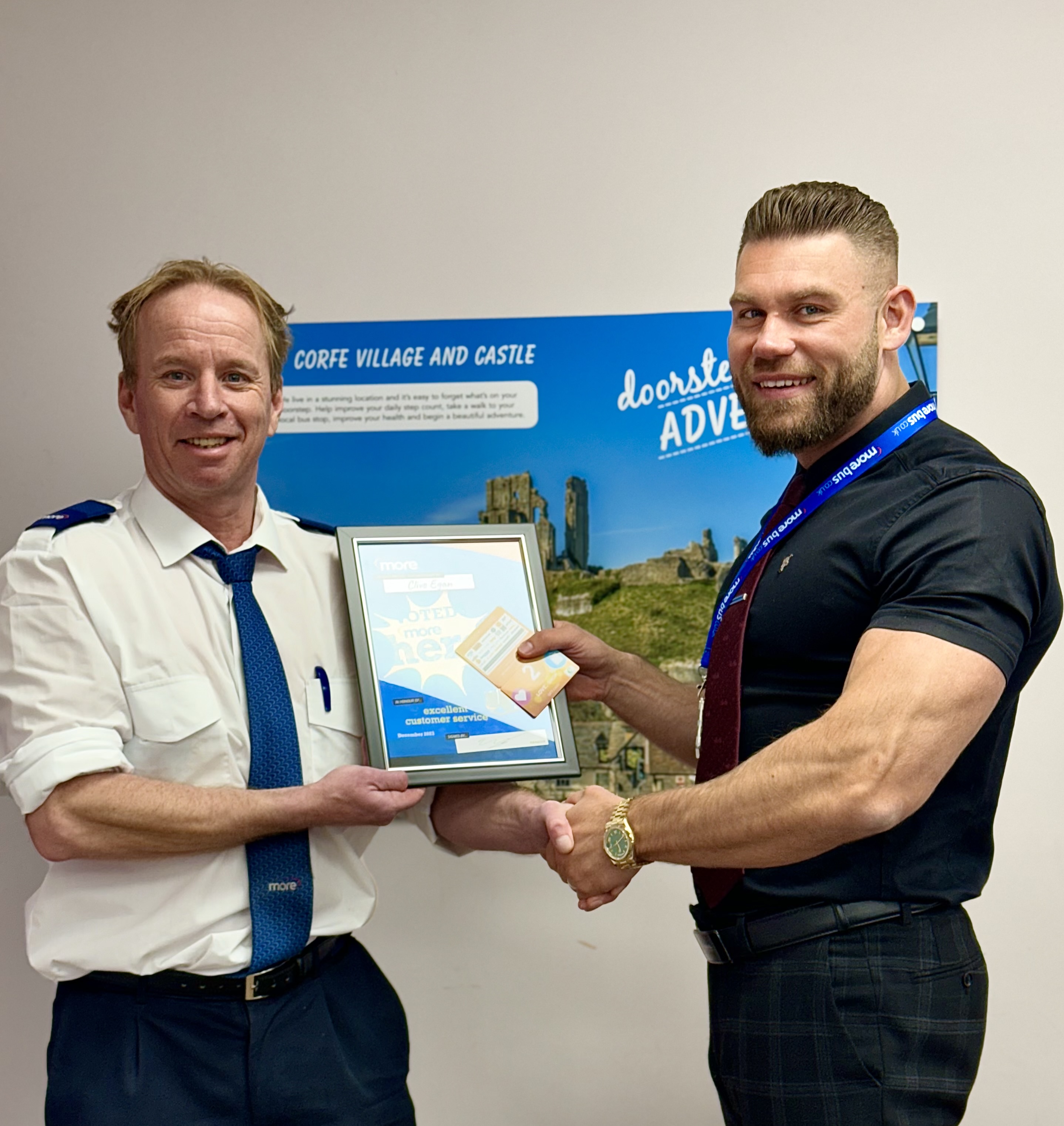 image of a driver being presented with a certificate whilst shaking hands