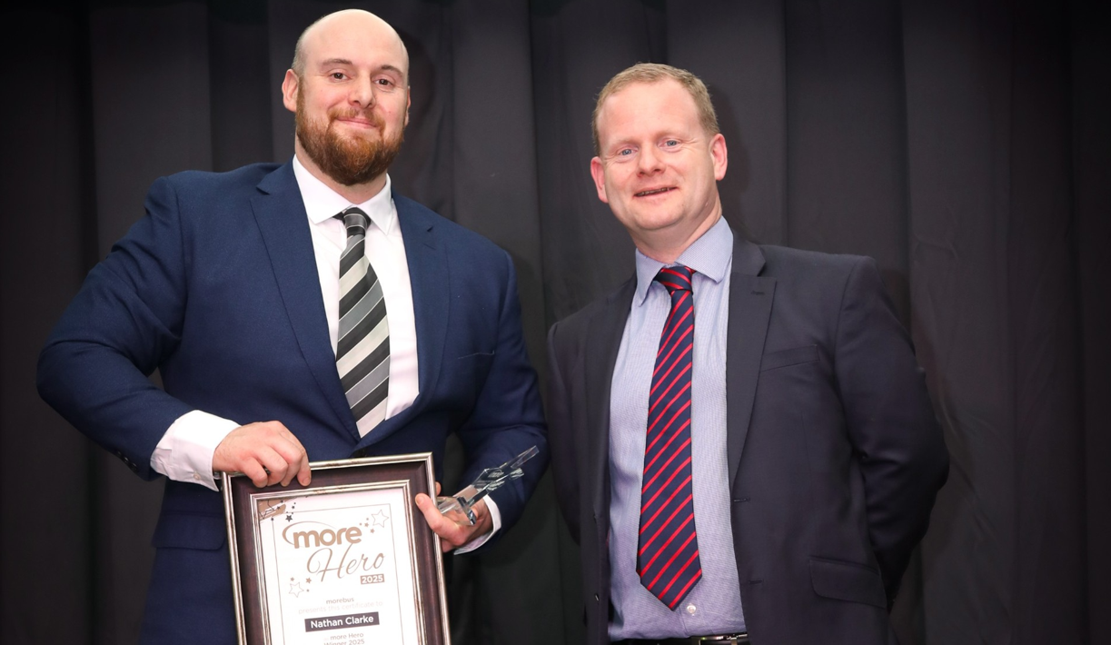 Nathan Clarke stood next to MD Ed Wills with his certificate and trophy