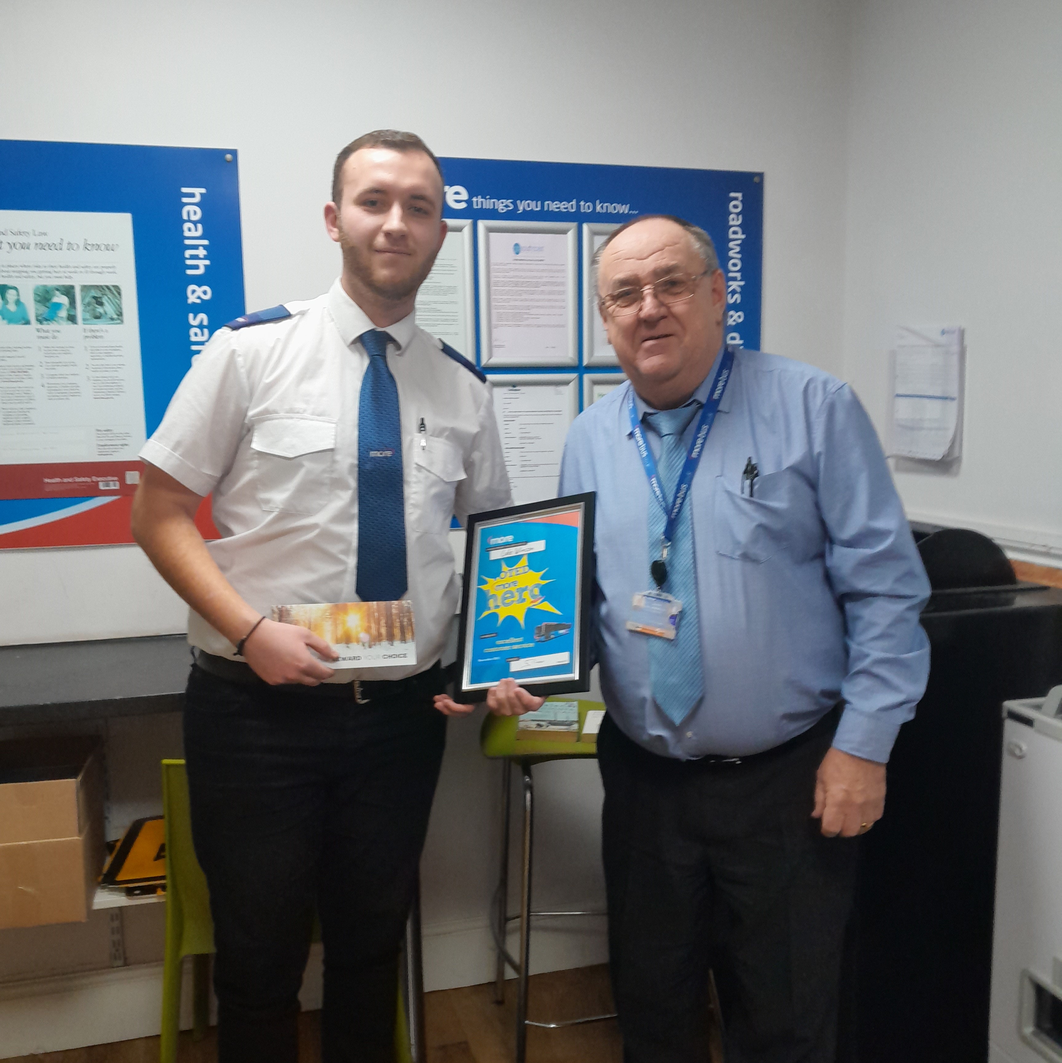 image of a driver being presented with a certificate whilst shaking hands