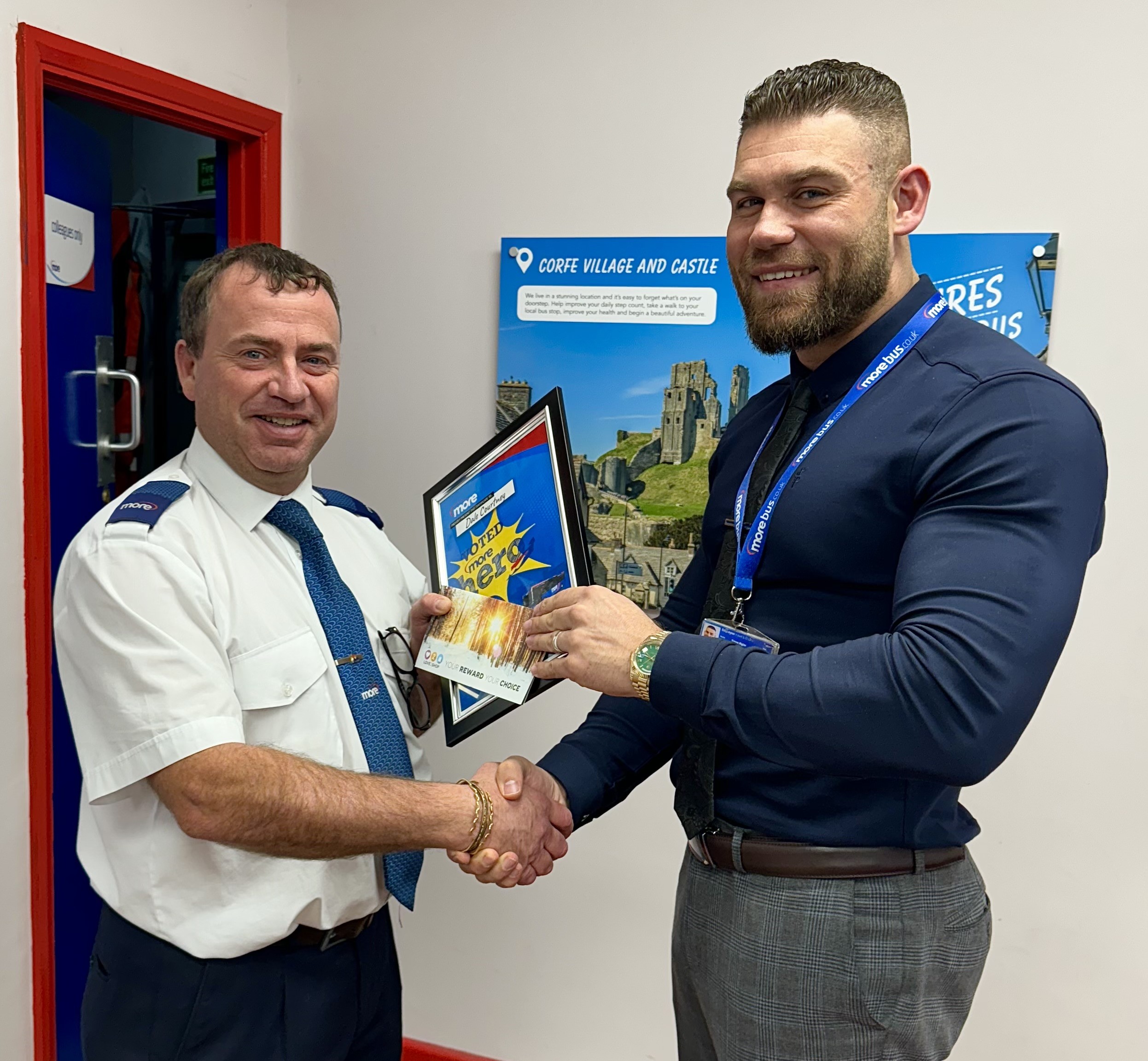 Manager presenting a driver with an award 
