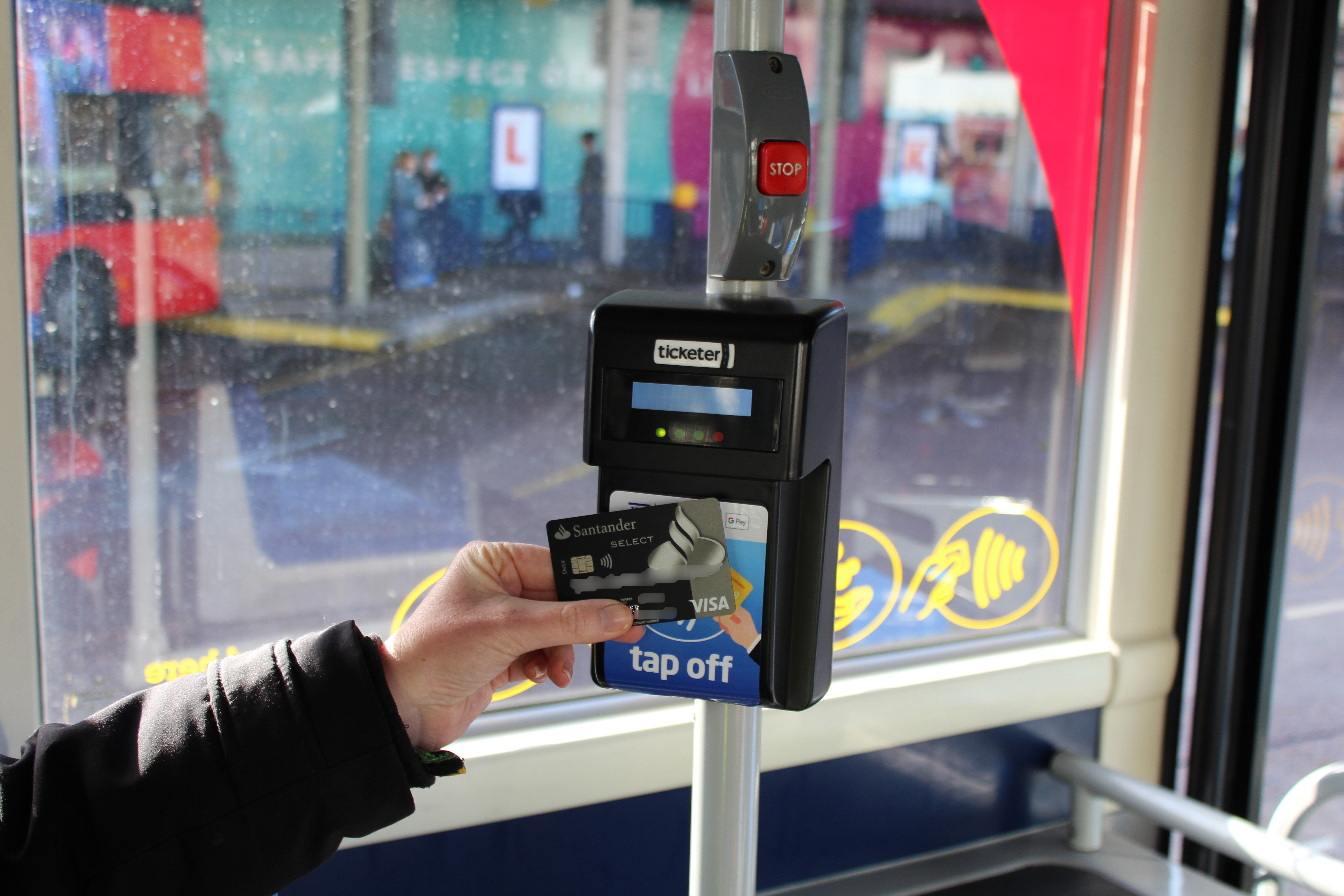 tap on tap off contactless payment - tap off reader on bus